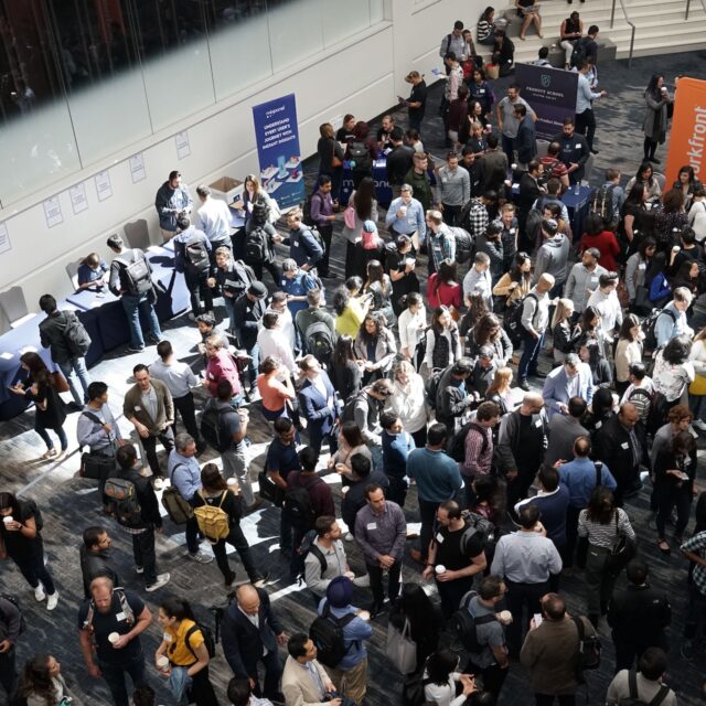 A large crowd gathered indoors for an event or meeting.